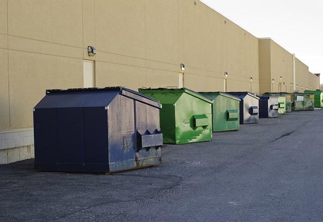 a yellow construction dumpster filled with waste materials in Inkerman, PA